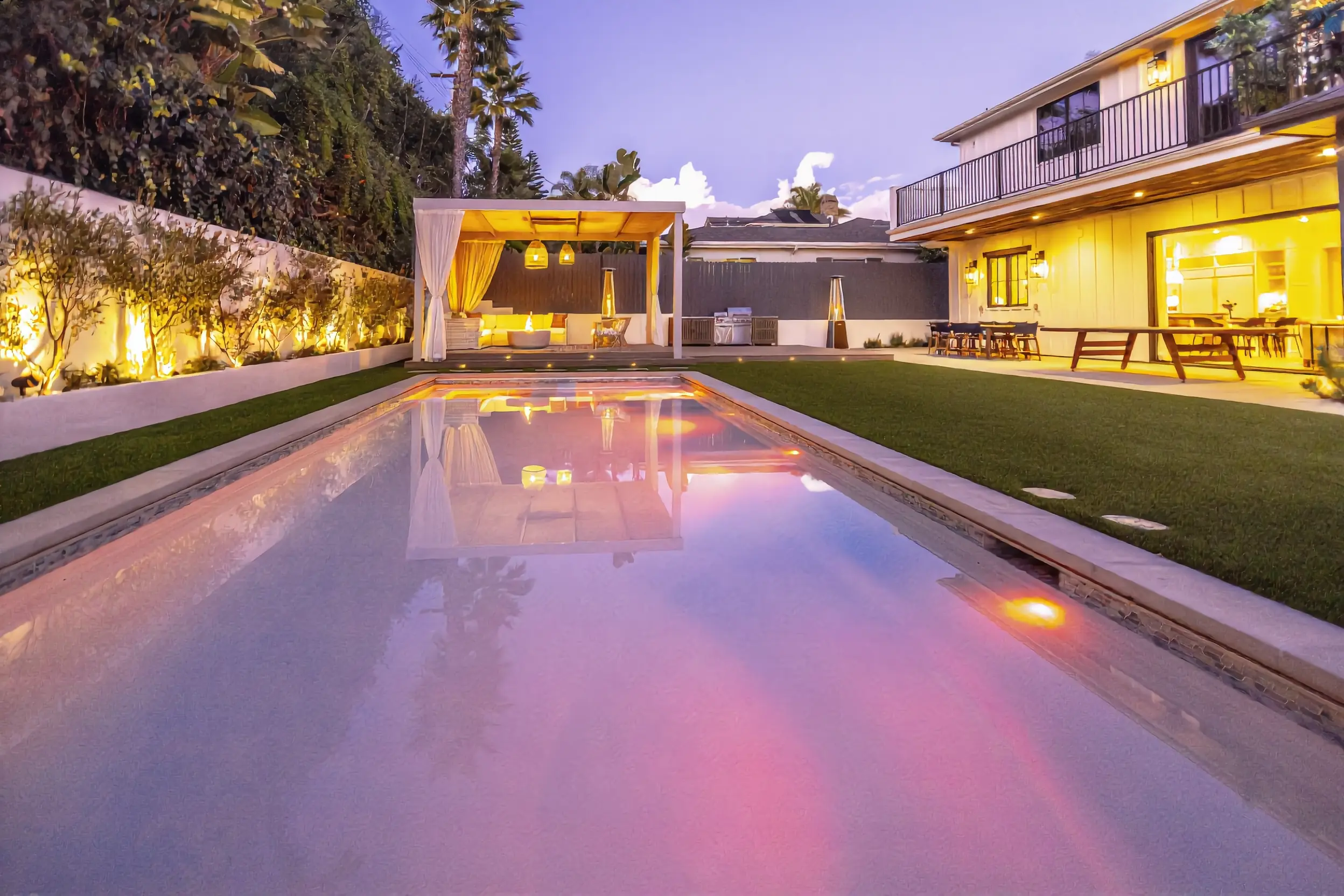 Backyard pool with cabana, fire pit, and outdoor kitchen in Los Angeles