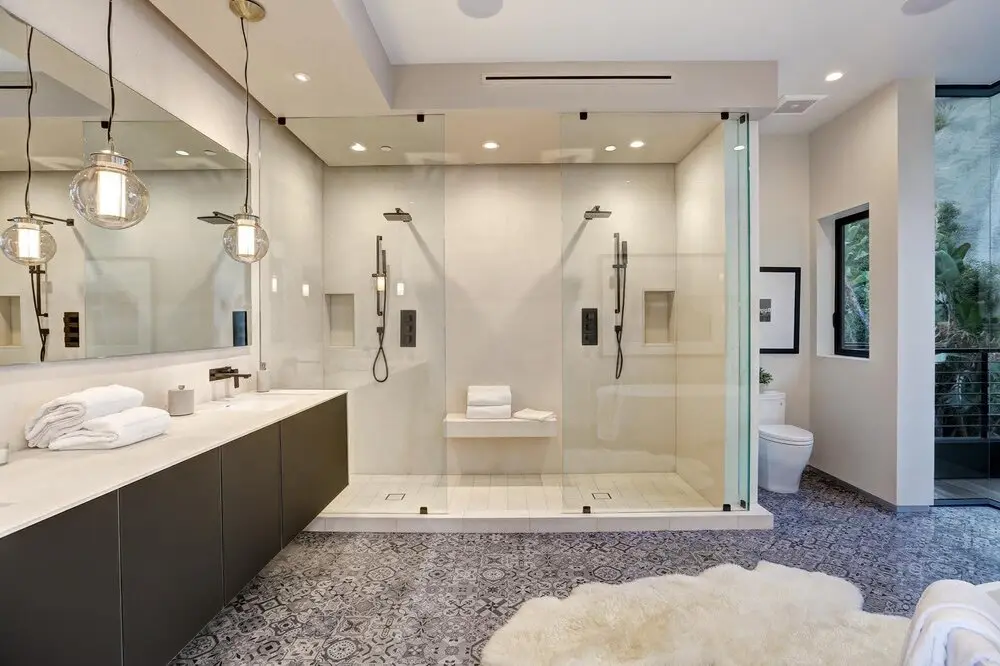 Bathroom remodel in Los Angeles with dual showers and patterned tile flooring