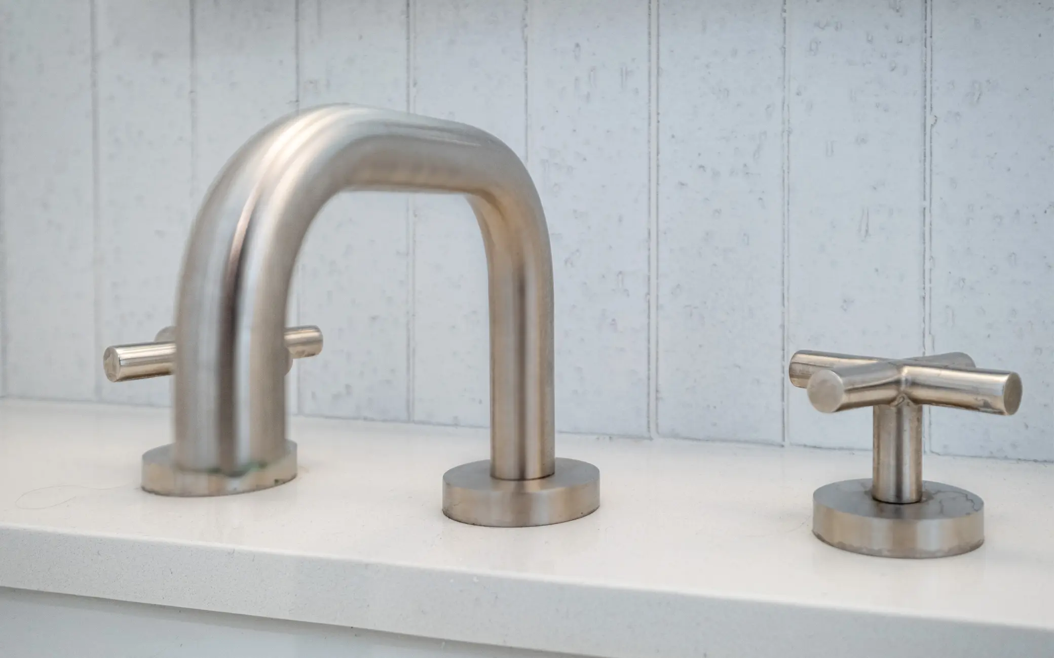 Detail of a brushed nickel widespread faucet in a Los Angeles bathroom remodel