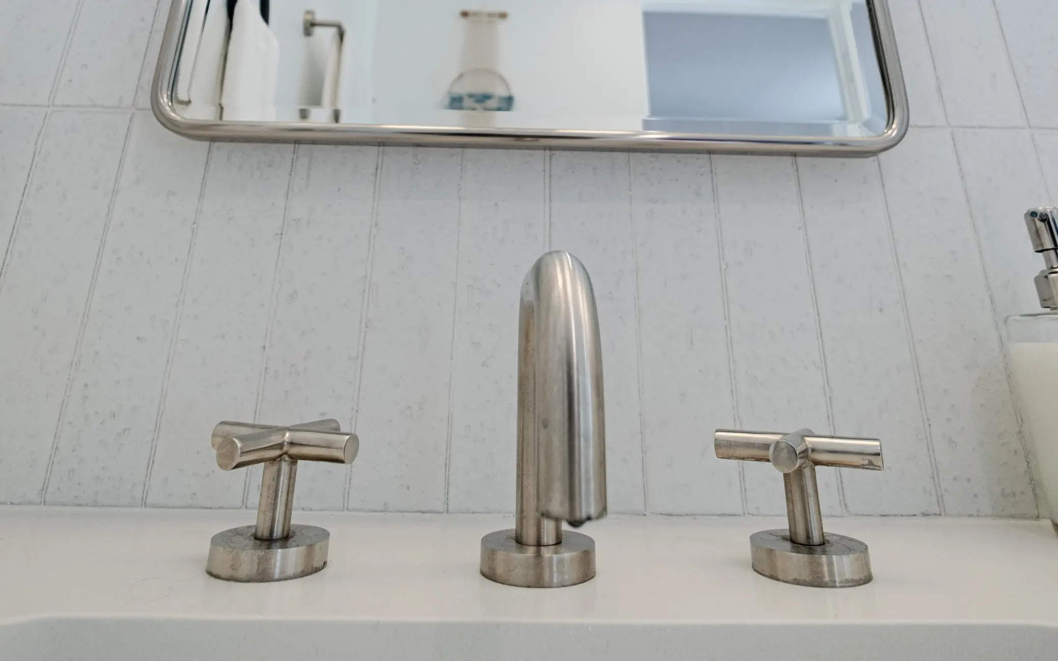 Detail of brushed nickel faucet fixtures in a Los Angeles bathroom remodel