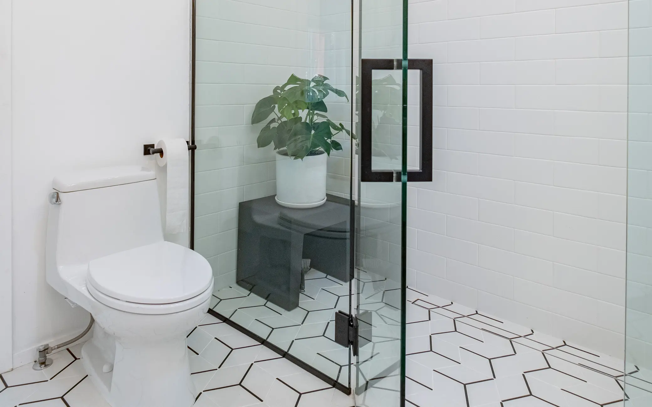 Bathroom remodel in Los Angeles with a glass shower and hexagon floor tile