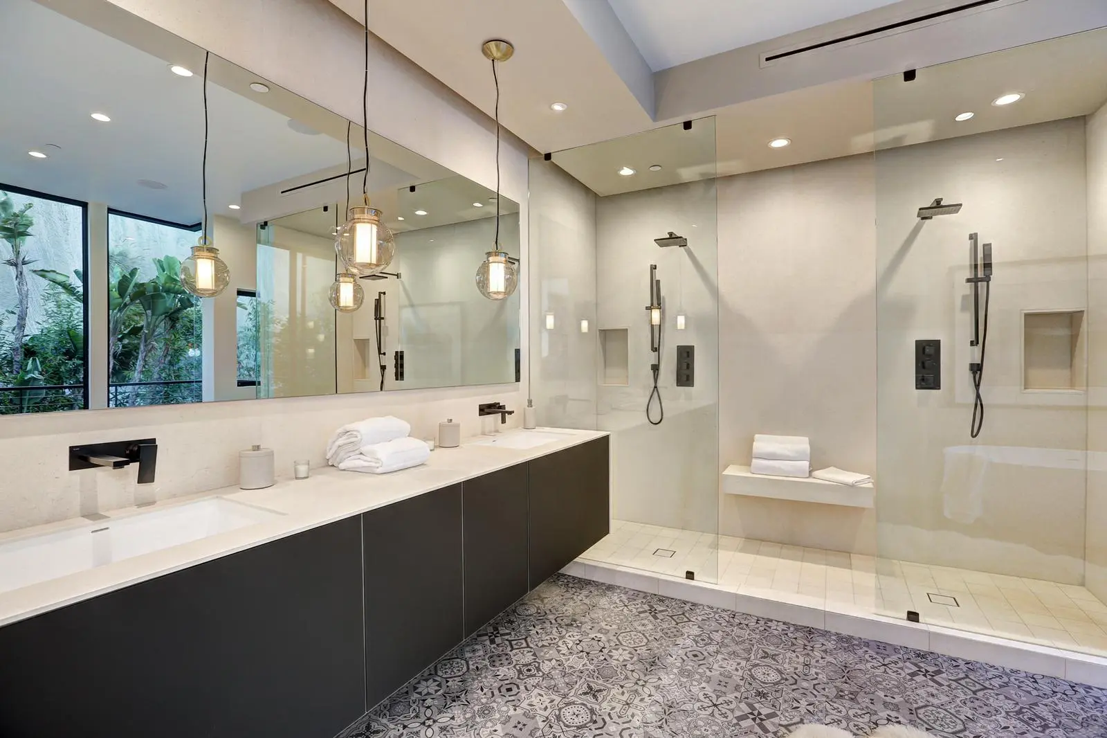 Bathroom remodel in Los Angeles with dual walk-in showers and patterned tile floor