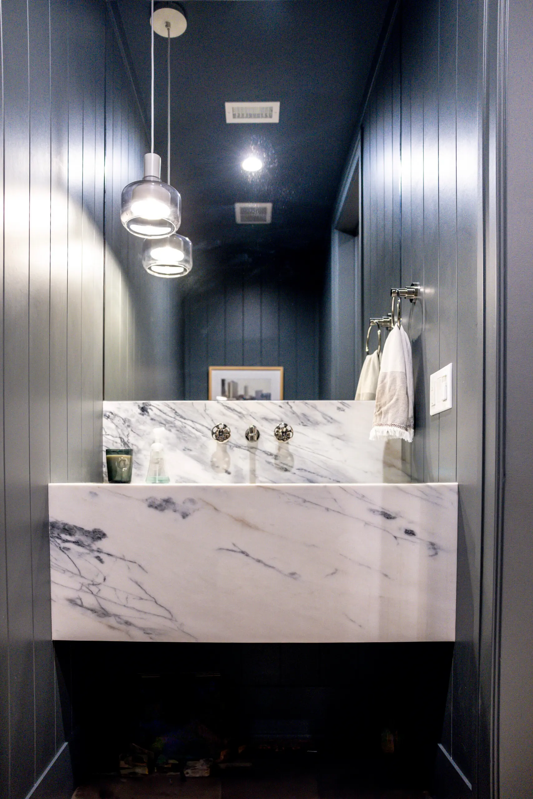 Bathroom remodel in Los Angeles with a floating marble vanity and pendant lighting