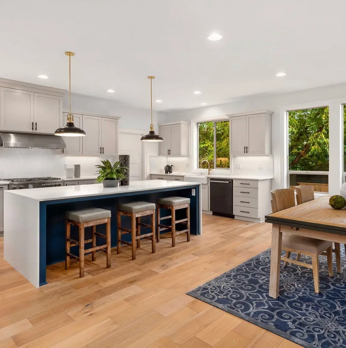 Custom kitchen remodel in Los Angeles with a navy blue island and white oak flooring