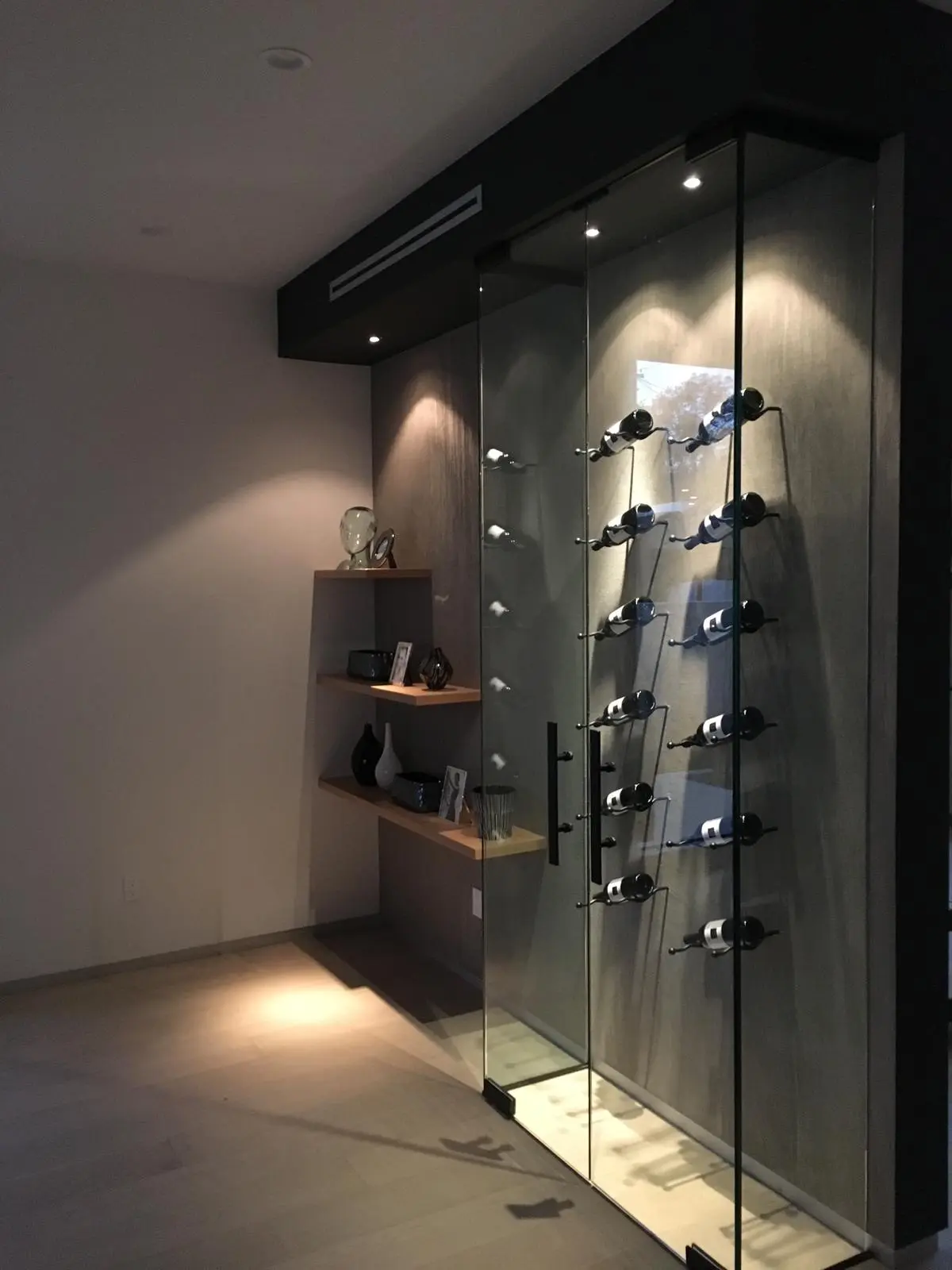 Custom glass-enclosed wine wall in a Los Angeles full home renovation