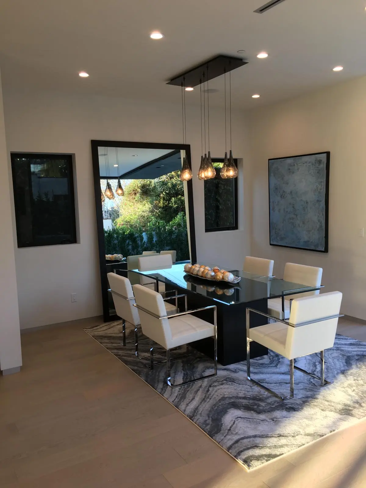 Dining room with sculptural pendant lighting in a Los Angeles full home renovation