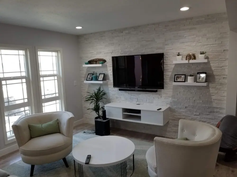 Living room with a stacked stone accent wall in a Los Angeles full home renovation