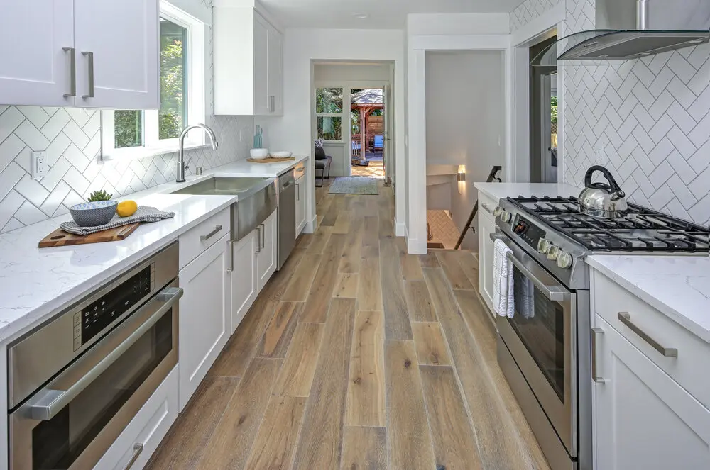 Kitchen remodel in Los Angeles featuring a white herringbone subway tile backsplash