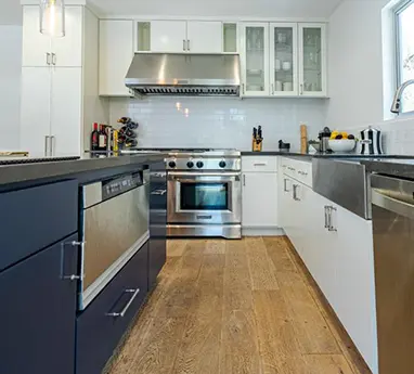 Kitchen remodel in Los Angeles with white cabinetry and stainless steel appliances
