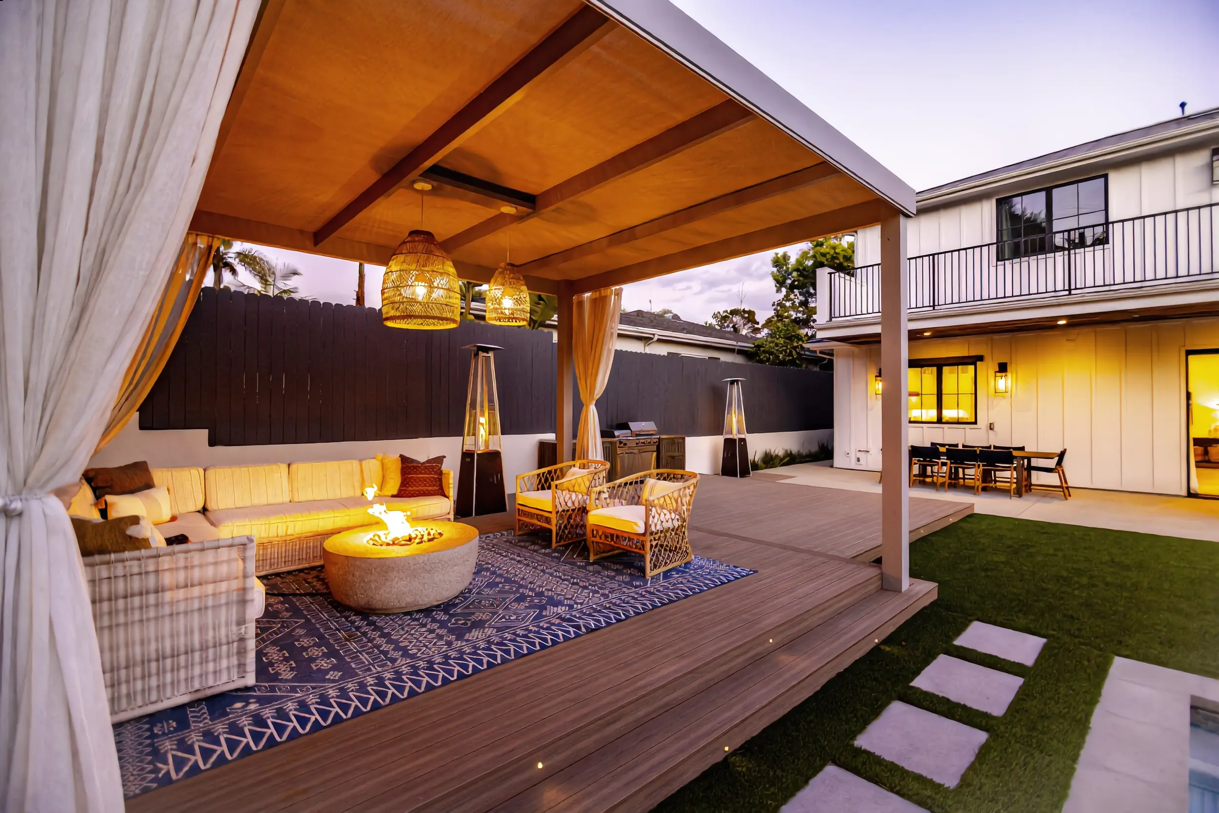 Solid roof patio cover with fire pit lounge on a composite deck in Los Angeles