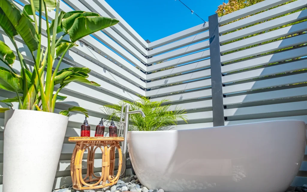 Backyard water feature with sculptural outdoor bath and tropical planting in Los Feliz