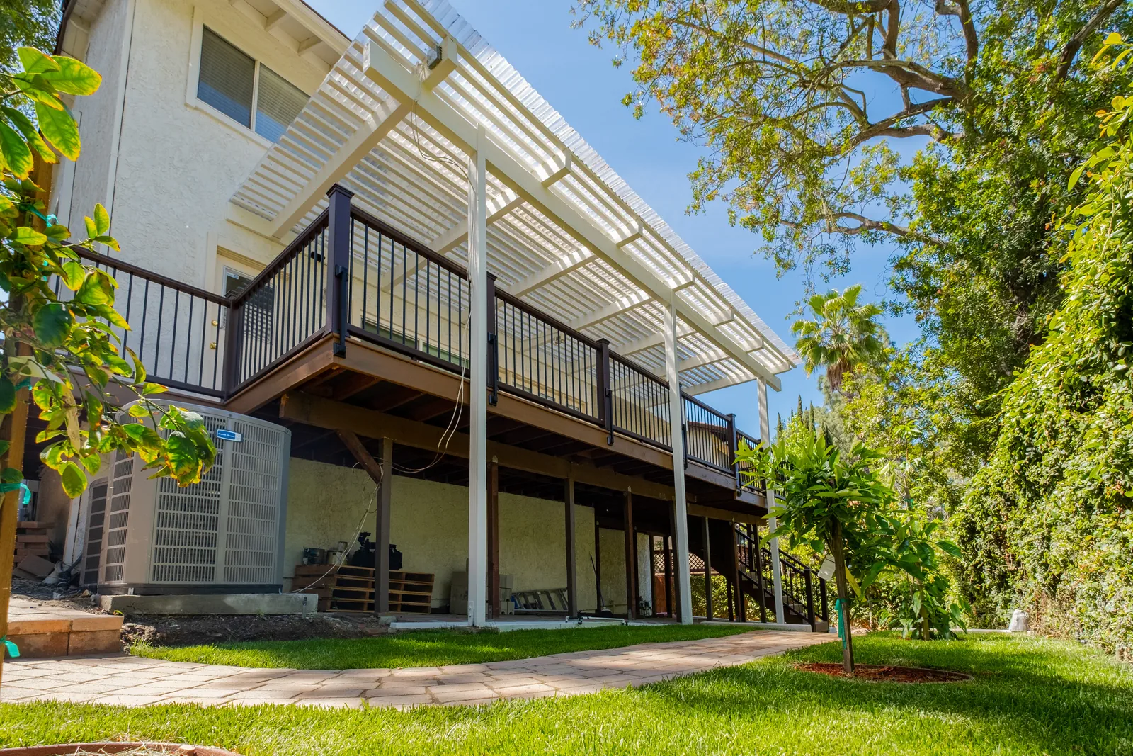 Wide view of a custom multi-level composite deck and patio cover attached to a Beverly Glen home in Los Angeles