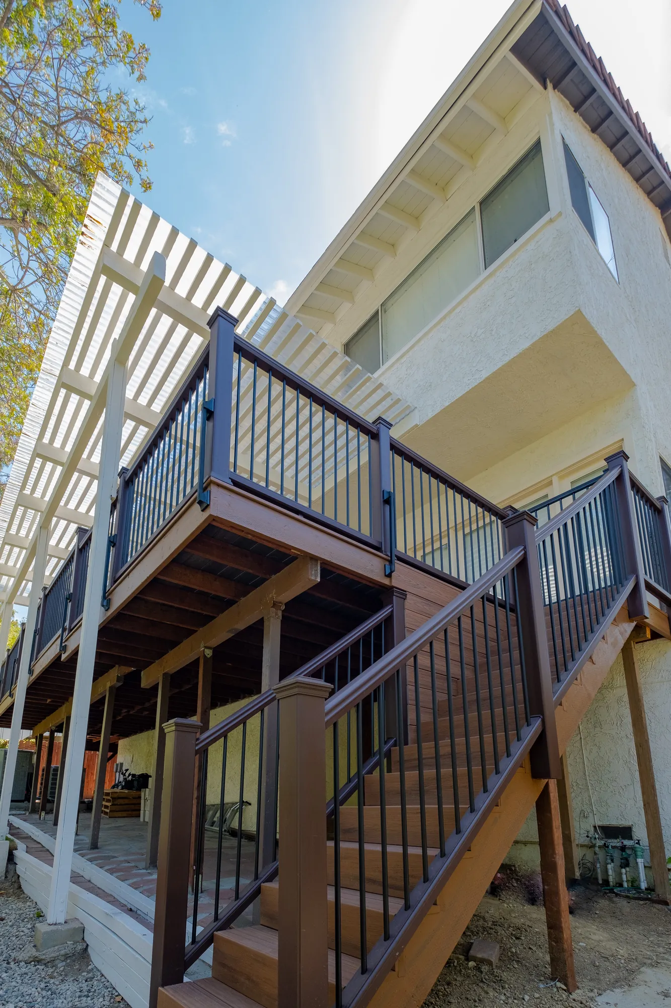 Exterior stairs and black railings on a two-story custom deck in Beverly Glen, Los Angeles