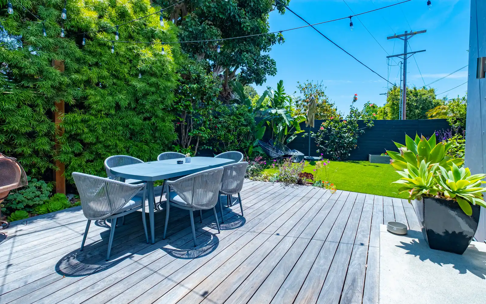 Composite deck with outdoor dining set in a Santa Monica backyard