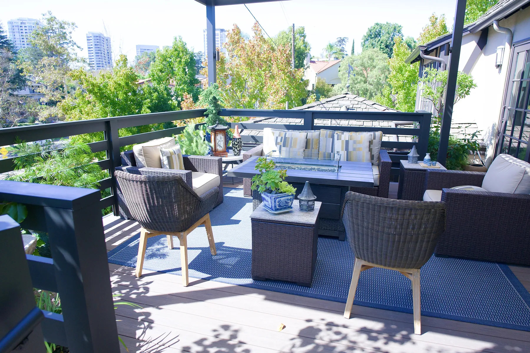 Wicker lounge on a modern Japanese pergola deck overlooking the city skyline in Los Angeles