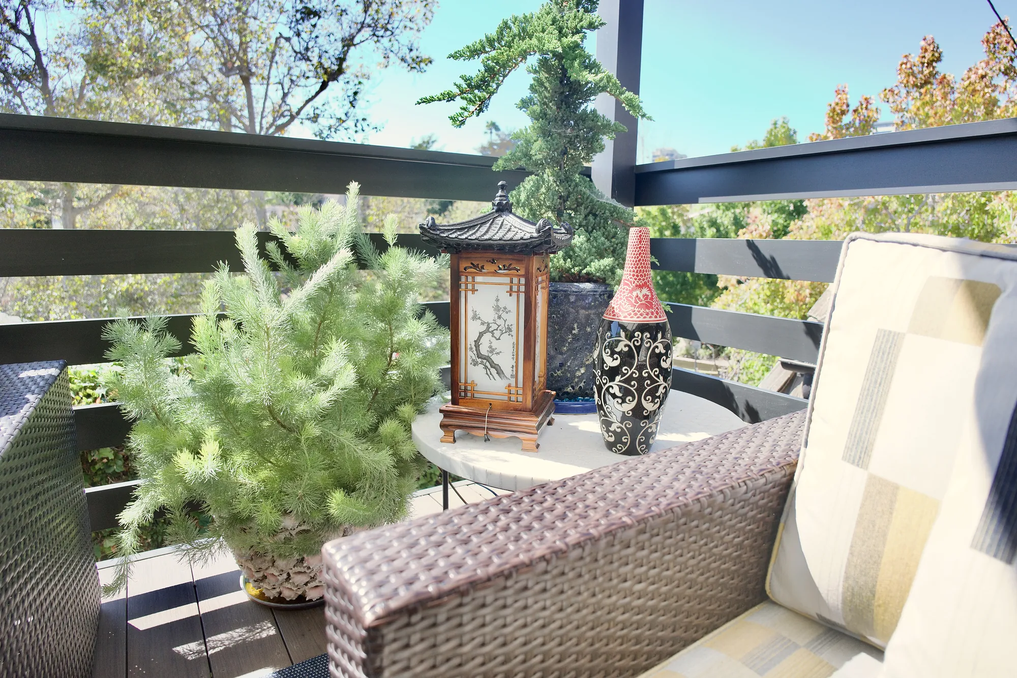 Pagoda lantern, bonsai, and horizontal deck railing on a modern Japanese pergola deck in Los Angeles