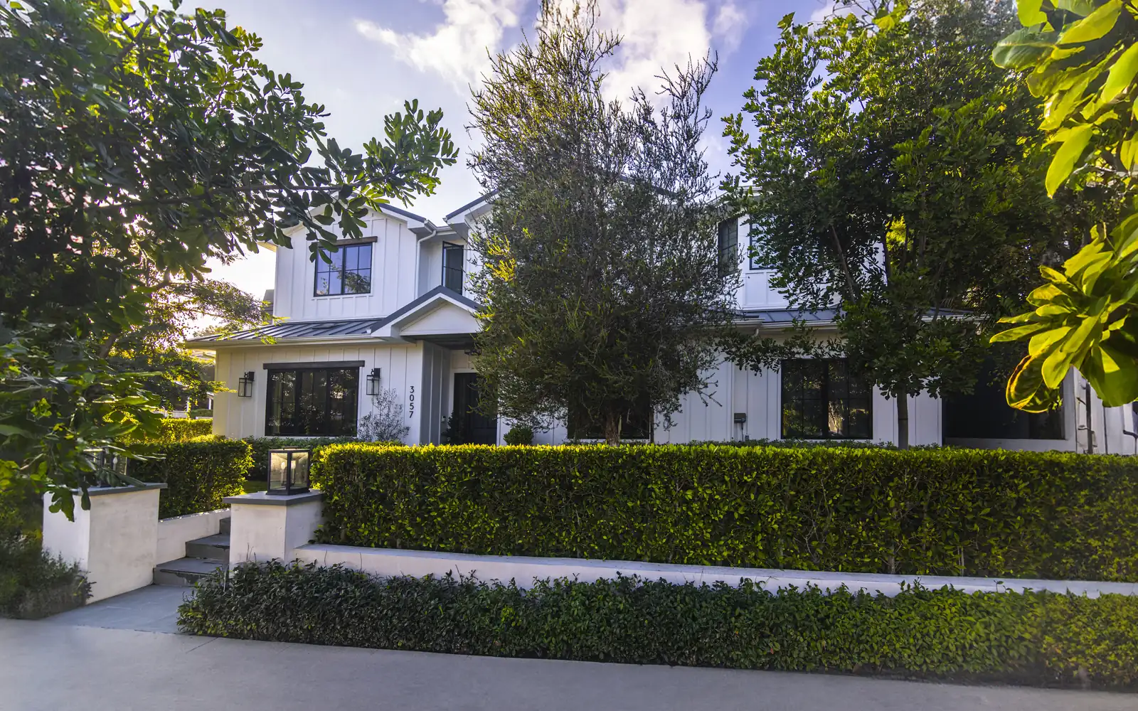 Manicured front lawn and hedges at a renovated Cheviot Hills home