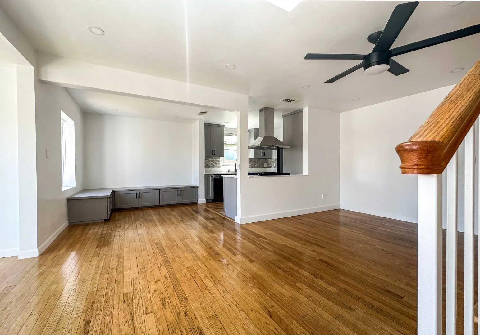 Open living space with refinished oak floors leading to a remodeled kitchen in Santa Monica