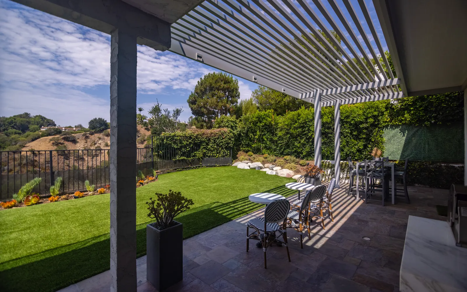 Modern louvered pergola over a landscaped patio in Beverly Glen