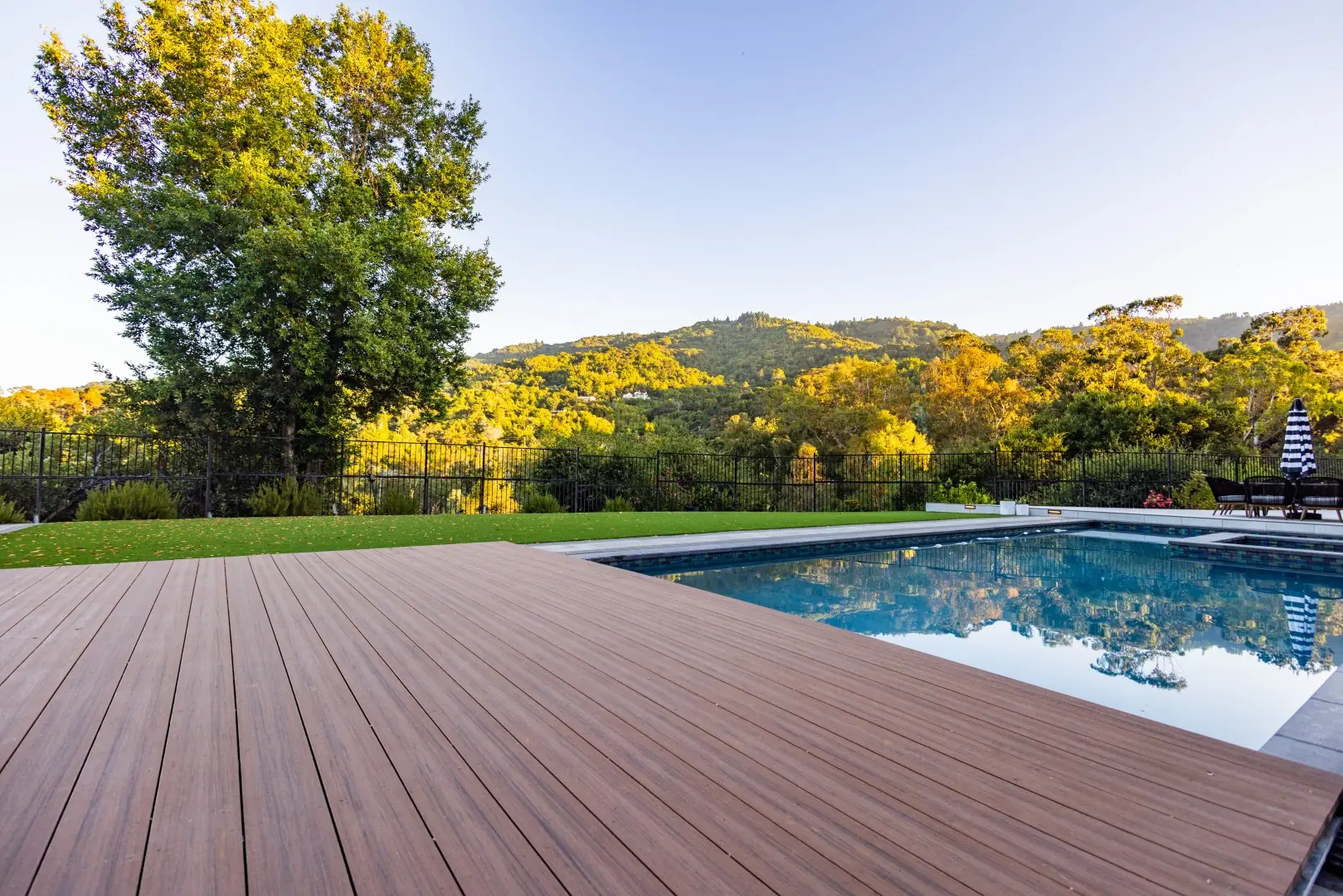 Composite boards of a movable pool deck partly covering the pool, with hillside views in San Jose, California