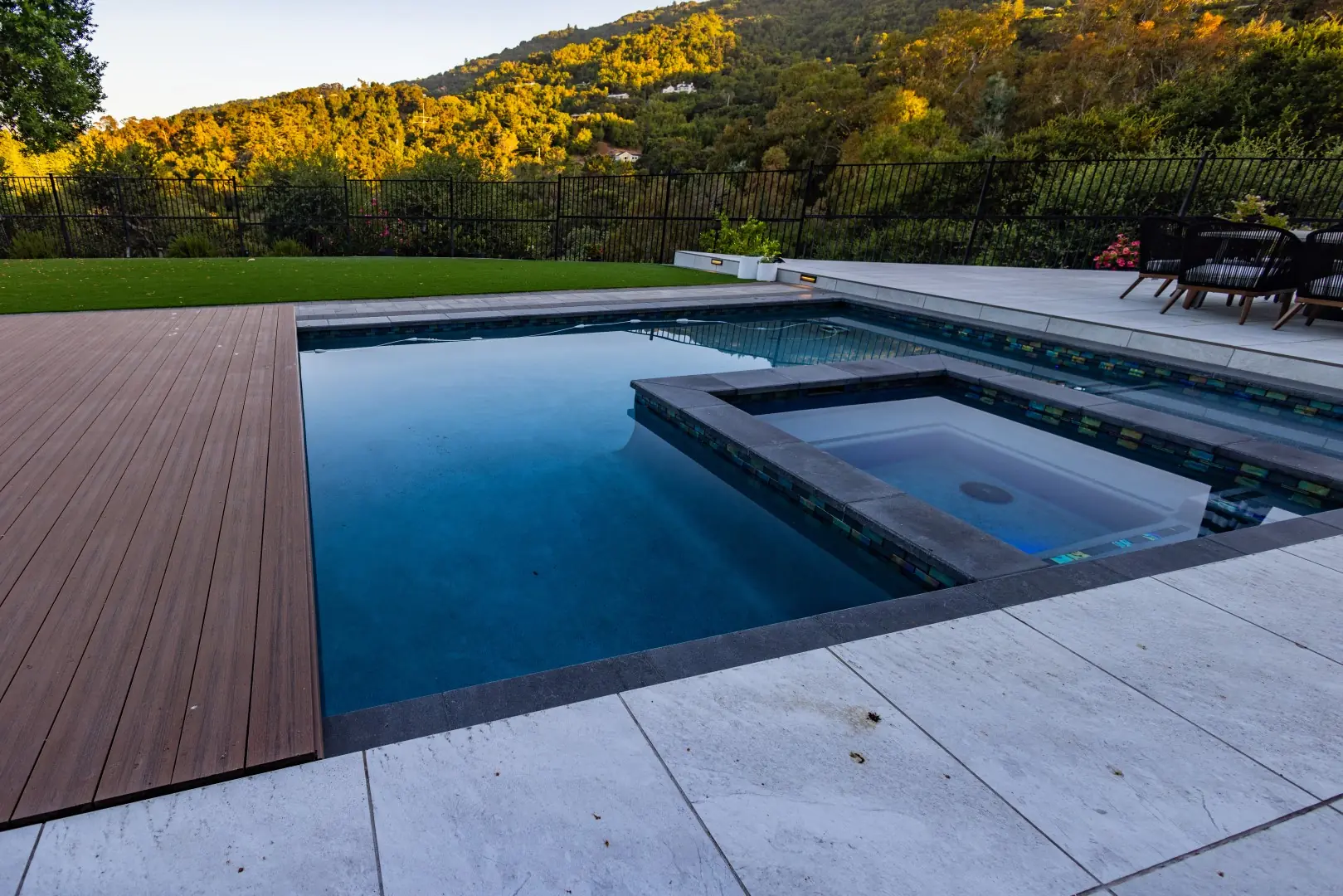 Edge of a movable composite deck beside a dark-finish pool and spa with hillside views in San Jose, California