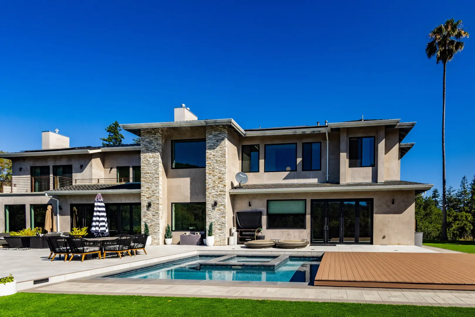 Modern home with a pool and spa partly covered by a movable composite deck in San Jose, California