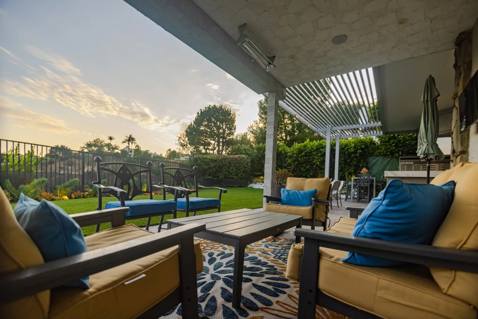 Outdoor lounge with cushioned seating under a patio cover at sunset in Beverly Glen, Los Angeles