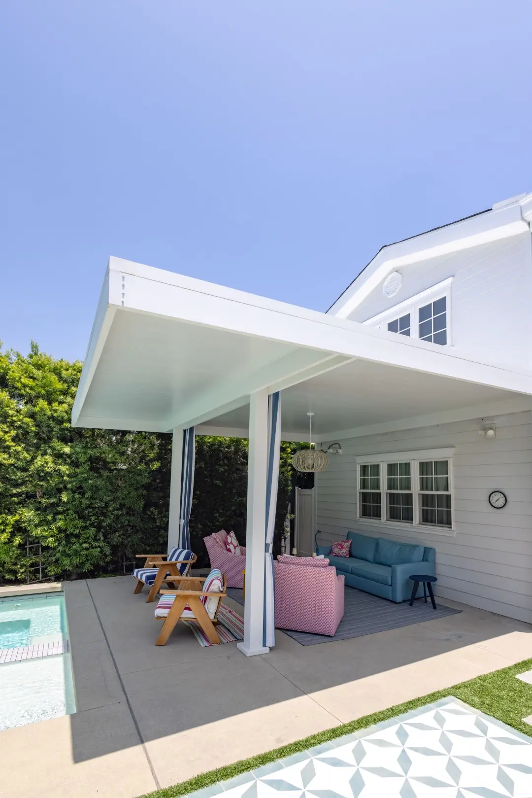 Attached white patio cover with lounge seating on a concrete patio at a Studio City home
