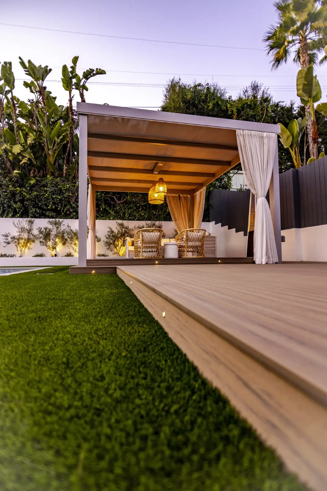 Sheens Project cabana pergola at dusk seen from the edge of the composite deck in Los Angeles