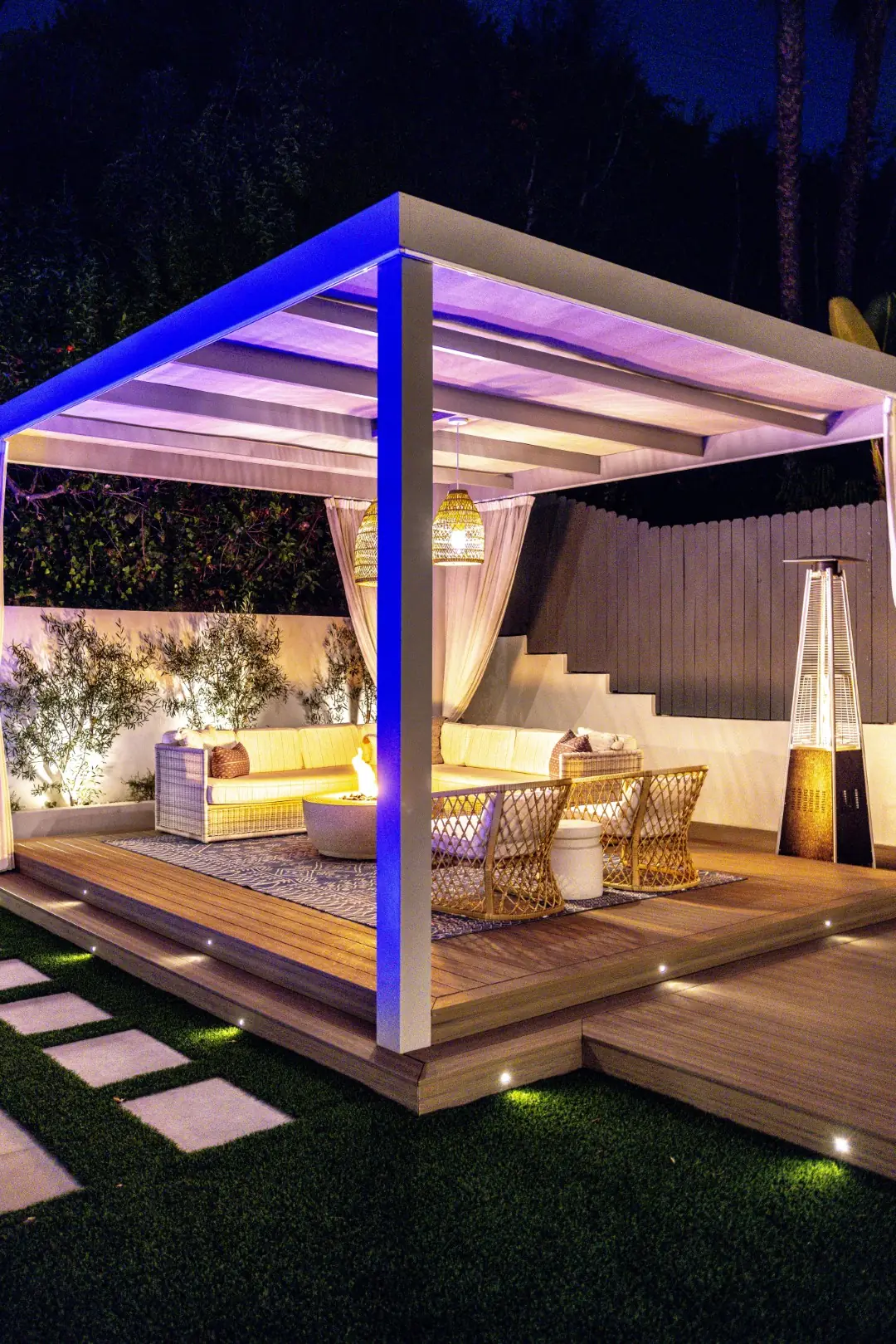 Sheens Project cabana pergola with LED accent lighting and a patio heater on the composite deck at night in Los Angeles