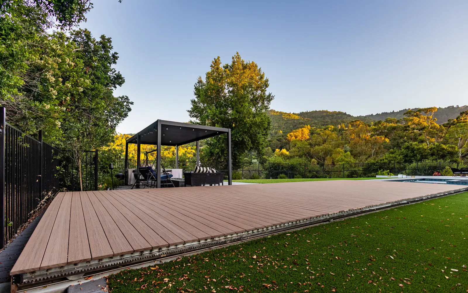 Sliding pool cover deck with hillside views in San Jose